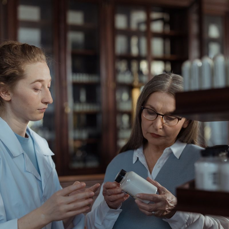 Une pharmacienne remet un produit à une cliente